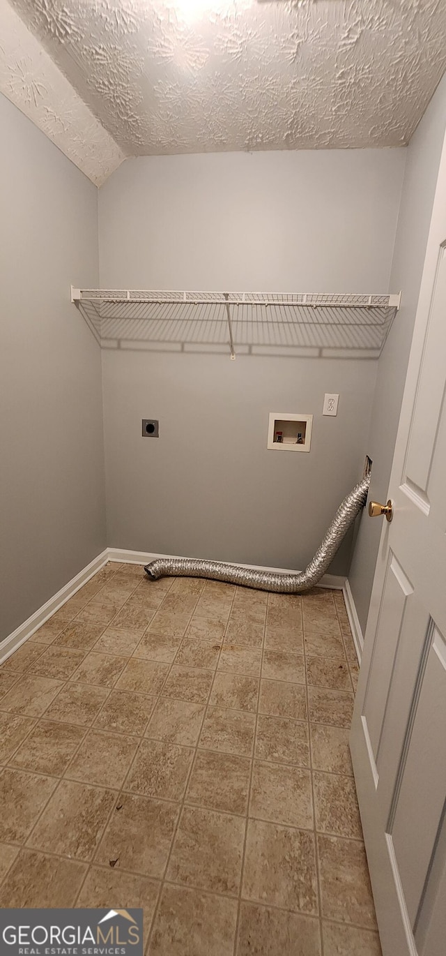 laundry room featuring washer hookup, laundry area, electric dryer hookup, a textured ceiling, and baseboards