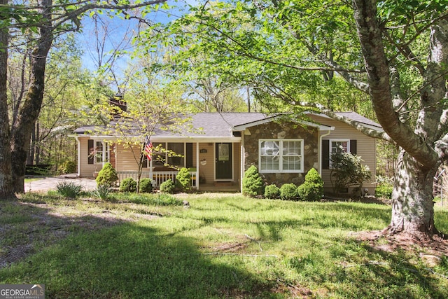 single story home with a front lawn, a porch, and stone siding