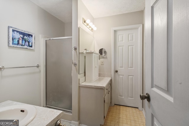 full bath featuring vanity, tile patterned floors, and a stall shower
