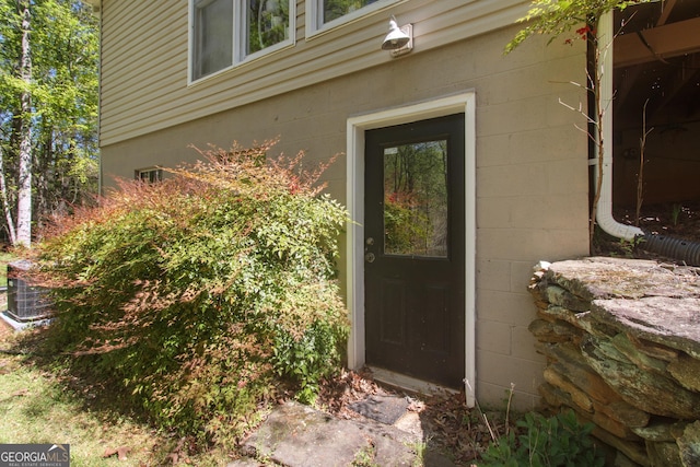 view of exterior entry with concrete block siding