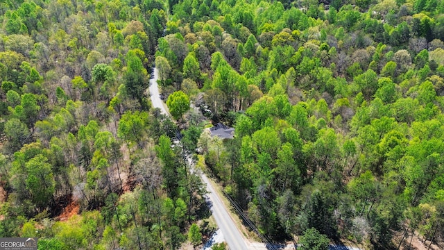 drone / aerial view featuring a forest view