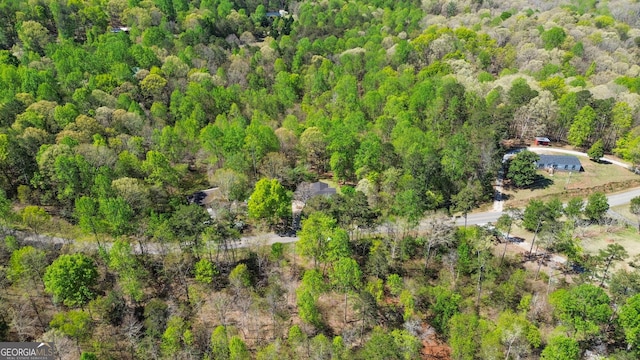 birds eye view of property featuring a view of trees