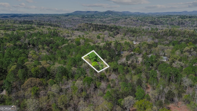 drone / aerial view featuring a view of trees and a mountain view