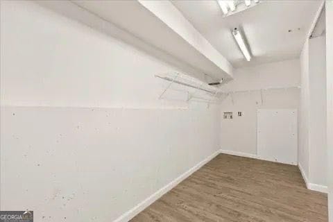 2317 Rocksram Ct, Buford, GA 30519 - walk in closet featuring wood finished floors