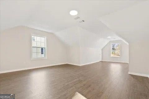 2317 Rocksram Ct, Buford, GA 30519 - bonus room featuring baseboards, wood finished floors, and vaulted ceiling