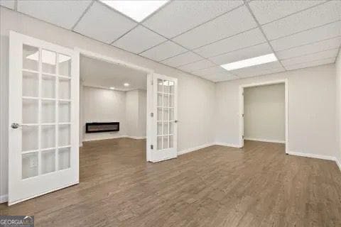 2317 Rocksram Ct, Buford, GA 30519 - below grade area with baseboards, french doors, wood finished floors, and a paneled ceiling