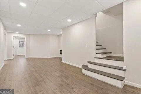 2317 Rocksram Ct, Buford, GA 30519 - finished basement with baseboards, stairs, and wood finished floors