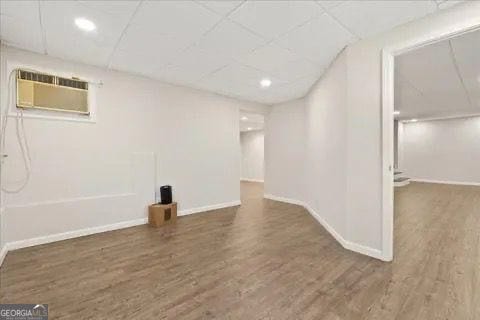2317 Rocksram Ct, Buford, GA 30519 - finished basement featuring baseboards, wood finished floors, and a wall mounted air conditioner