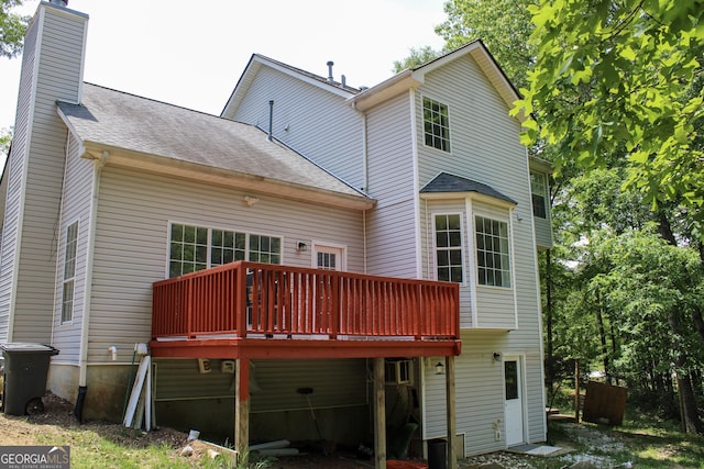 2317 Rocksram Ct, Buford, GA 30519 - rear view of property featuring roof with shingles, a wooden deck, and a chimney