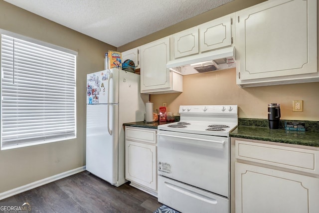 108 Magnolia Plantation Trce Unit 108, Hinesville, GA 31313 - kitchen with dark countertops, white appliances, white cabinetry, dark wood finished floors, and under cabinet range hood