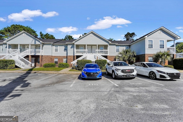 108 Magnolia Plantation Trce Unit 108, Hinesville, GA 31313 - view of front of house featuring brick siding, a porch, and stairway