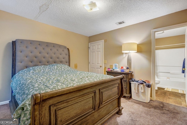 108 Magnolia Plantation Trce Unit 108, Hinesville, GA 31313 - bedroom featuring light colored carpet, ensuite bath, a textured ceiling, and visible vents