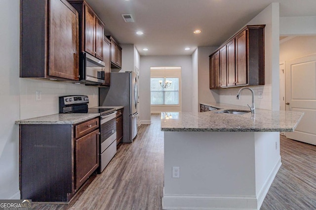 440 Dublin Way, Dallas, GA 30132 - kitchen featuring visible vents, wood finished floors, a sink, and appliances with stainless steel finishes