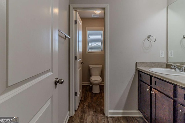 440 Dublin Way, Dallas, GA 30132 - bathroom featuring baseboards, wood finished floors, vanity, and toilet