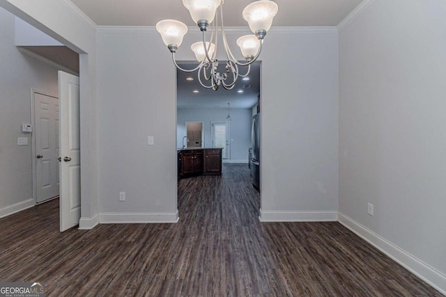 440 Dublin Way, Dallas, GA 30132 - empty room with dark wood-type flooring, crown molding, baseboards, and a notable chandelier