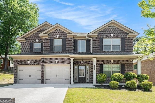 2212 Reddy Farm Ln, Grayson, GA 30017 - traditional-style house featuring a garage, concrete driveway, covered porch, a front yard, and brick siding
