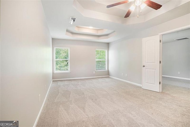 2212 Reddy Farm Ln, Grayson, GA 30017 - spare room with a ceiling fan, a tray ceiling, baseboards, carpet flooring, and visible vents