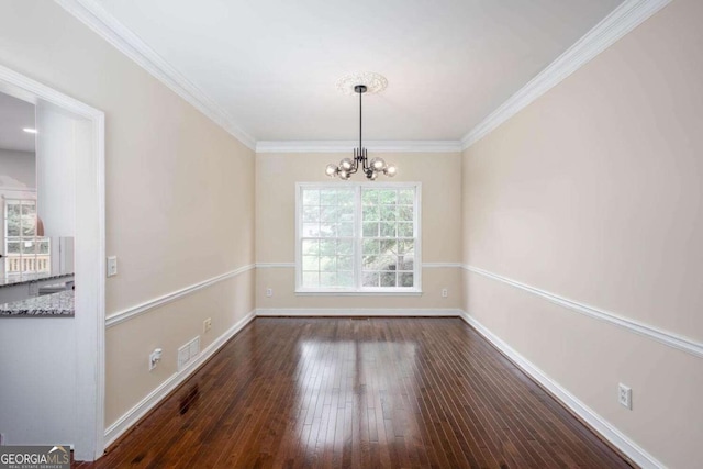 1533 Fallen Leaf Dr SW, Marietta, GA 30064 - unfurnished dining area with hardwood / wood-style flooring, an inviting chandelier, crown molding, and visible vents
