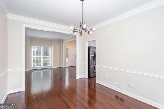 1533 Fallen Leaf Dr SW, Marietta, GA 30064 - unfurnished dining area with visible vents, crown molding, dark wood-style flooring, and an inviting chandelier