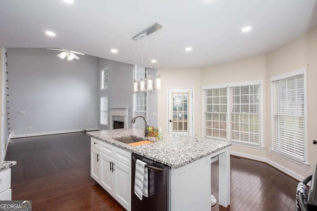 1533 Fallen Leaf Dr SW, Marietta, GA 30064 - kitchen featuring stainless steel dishwasher, a sink, ceiling fan, a fireplace, and dark wood-style flooring