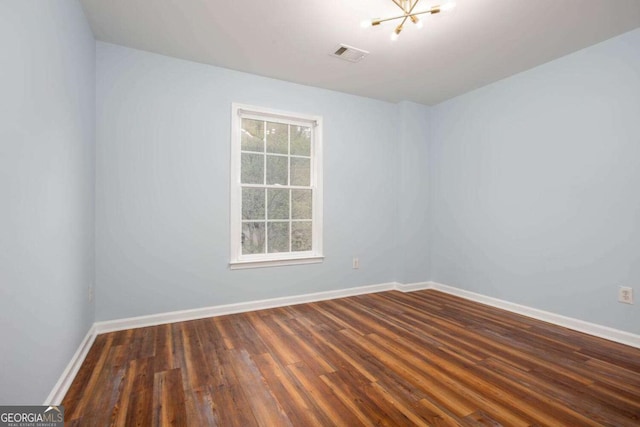 1533 Fallen Leaf Dr SW, Marietta, GA 30064 - unfurnished room featuring baseboards, a notable chandelier, wood finished floors, and visible vents