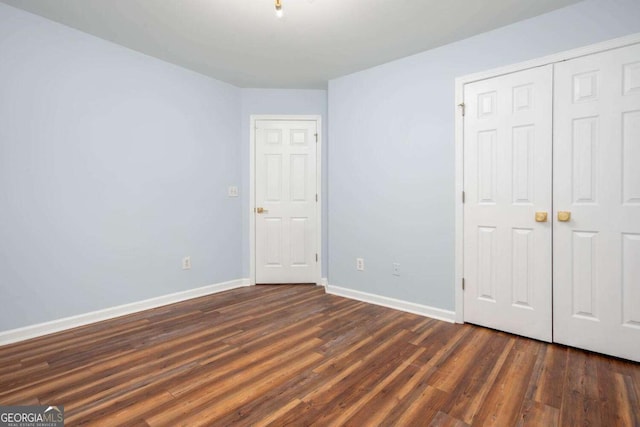 1533 Fallen Leaf Dr SW, Marietta, GA 30064 - unfurnished bedroom featuring dark wood finished floors, a closet, and baseboards