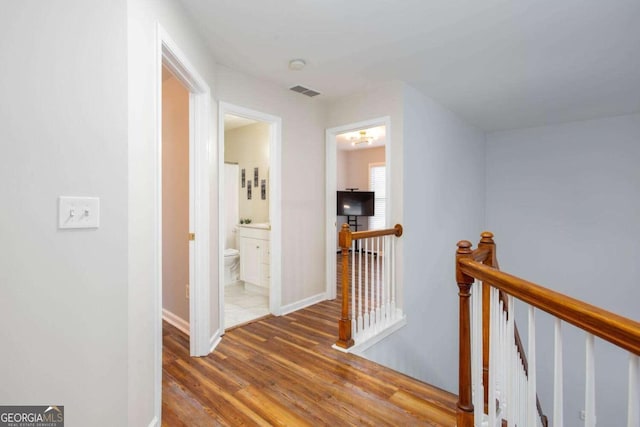 1533 Fallen Leaf Dr SW, Marietta, GA 30064 - corridor with visible vents, baseboards, wood finished floors, and an upstairs landing