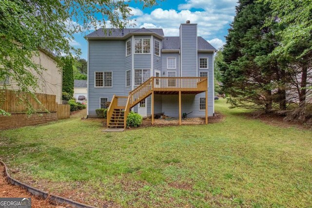 1533 Fallen Leaf Dr SW, Marietta, GA 30064 - back of property with a chimney, stairs, fence, a lawn, and a deck