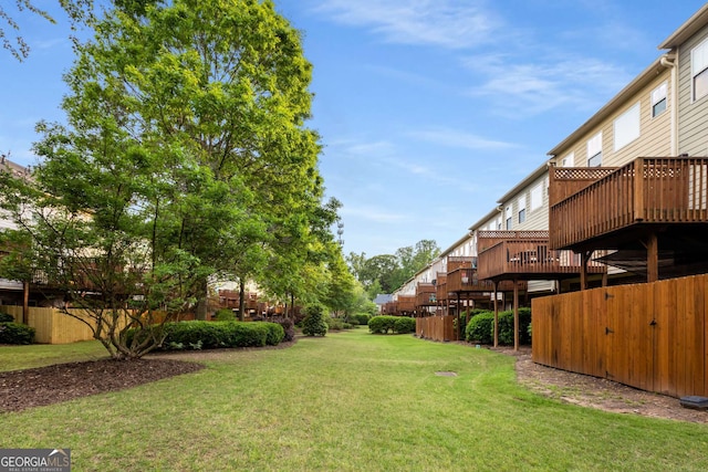 view of yard with a deck and fence