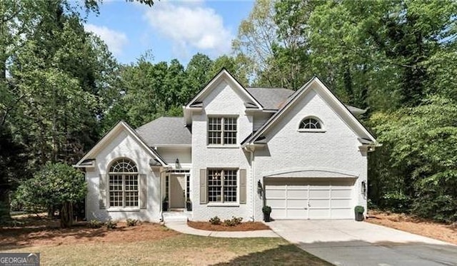 traditional-style house with an attached garage and concrete driveway