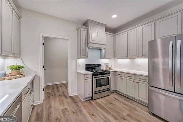 kitchen featuring light countertops, light wood-style floors, and appliances with stainless steel finishes