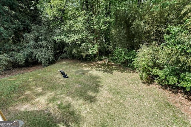 view of yard featuring a forest view