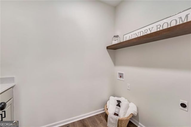 washroom featuring wood finished floors, hookup for an electric dryer, baseboards, cabinet space, and washer hookup