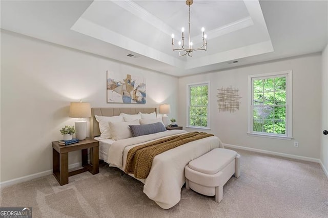 bedroom with baseboards, a chandelier, visible vents, and a raised ceiling