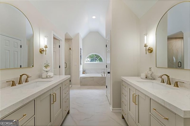 bathroom featuring vaulted ceiling, marble finish floor, a sink, and a shower stall
