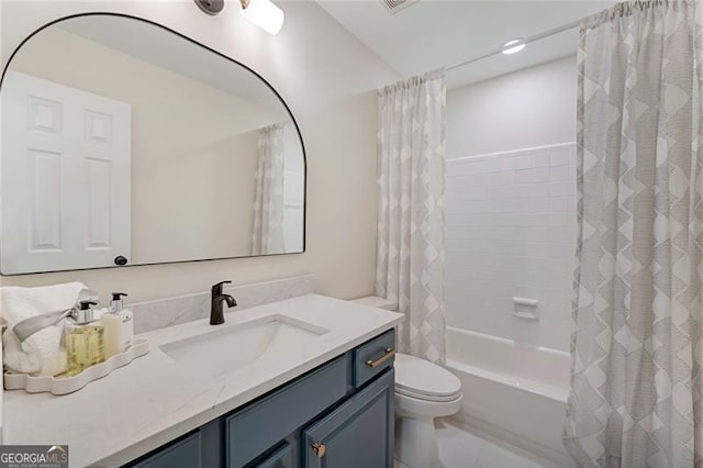 full bath with shower / tub combo, vanity, and toilet