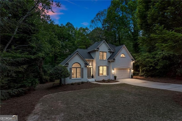 traditional-style home featuring driveway and a garage