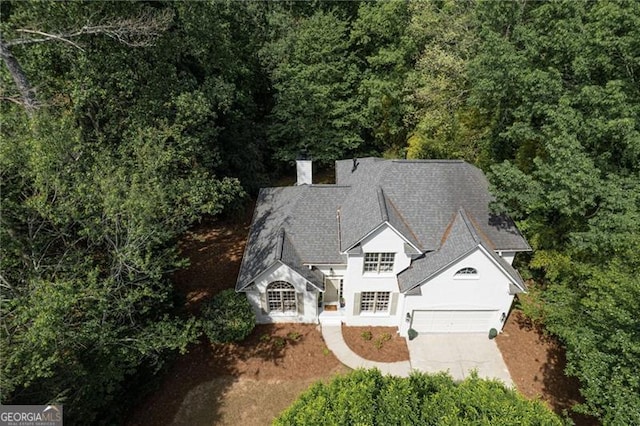 drone / aerial view featuring a wooded view
