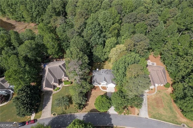 birds eye view of property featuring a wooded view
