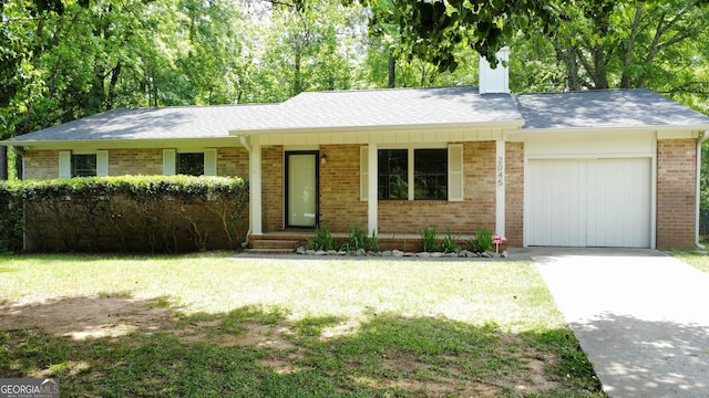 2045 Greentree Pkwy, Macon, GA 31220 - single story home featuring brick siding, an attached garage, a front yard, and driveway