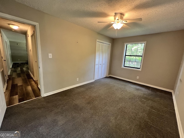 2045 Greentree Pkwy, Macon, GA 31220 - unfurnished bedroom with a textured ceiling, baseboards, a ceiling fan, dark carpet, and a closet