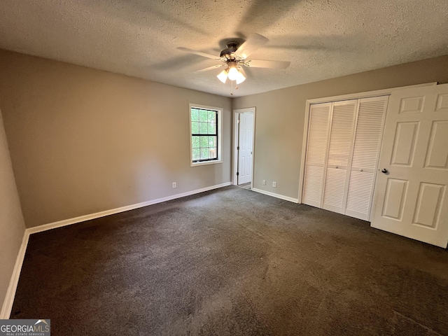 2045 Greentree Pkwy, Macon, GA 31220 - unfurnished bedroom with a closet, a ceiling fan, dark colored carpet, baseboards, and a textured ceiling