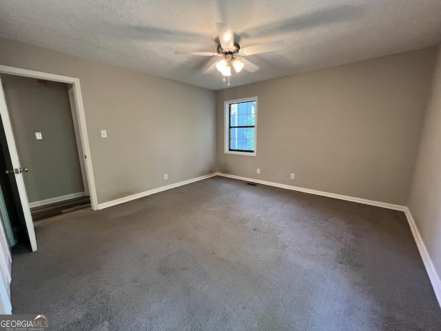 2045 Greentree Pkwy, Macon, GA 31220 - spare room with a textured ceiling, ceiling fan, dark colored carpet, and baseboards