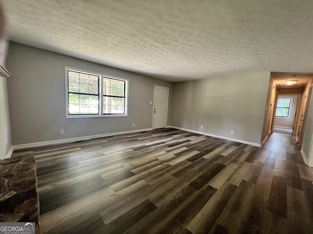 2045 Greentree Pkwy, Macon, GA 31220 - unfurnished living room with baseboards, dark wood-style flooring, and a textured ceiling