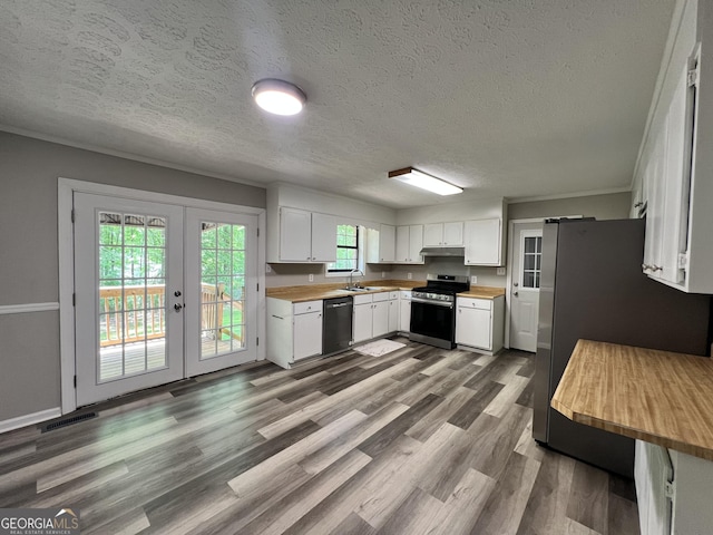2045 Greentree Pkwy, Macon, GA 31220 - kitchen featuring wood counters, a textured ceiling, stainless steel appliances, under cabinet range hood, and french doors
