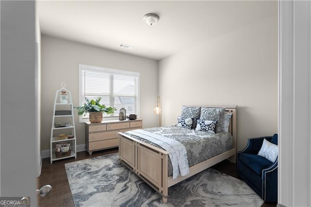 bedroom with visible vents and dark wood-style flooring