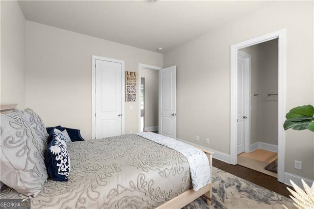 bedroom featuring wood finished floors and baseboards