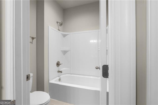 bathroom with tile patterned flooring,  shower combination, and toilet