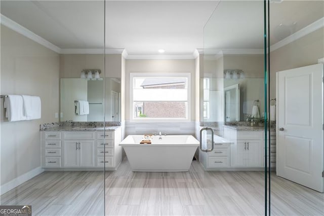 bathroom with vanity, crown molding, and a soaking tub
