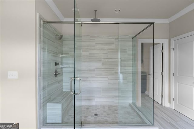 full bath with a shower stall and ornamental molding